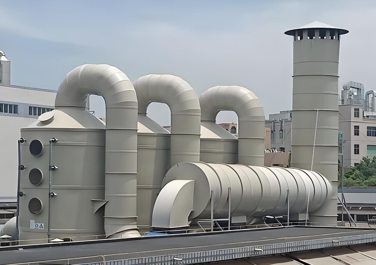 Industrial exhaust ductwork, fan housing, and stack at a rooftop treatment installation
