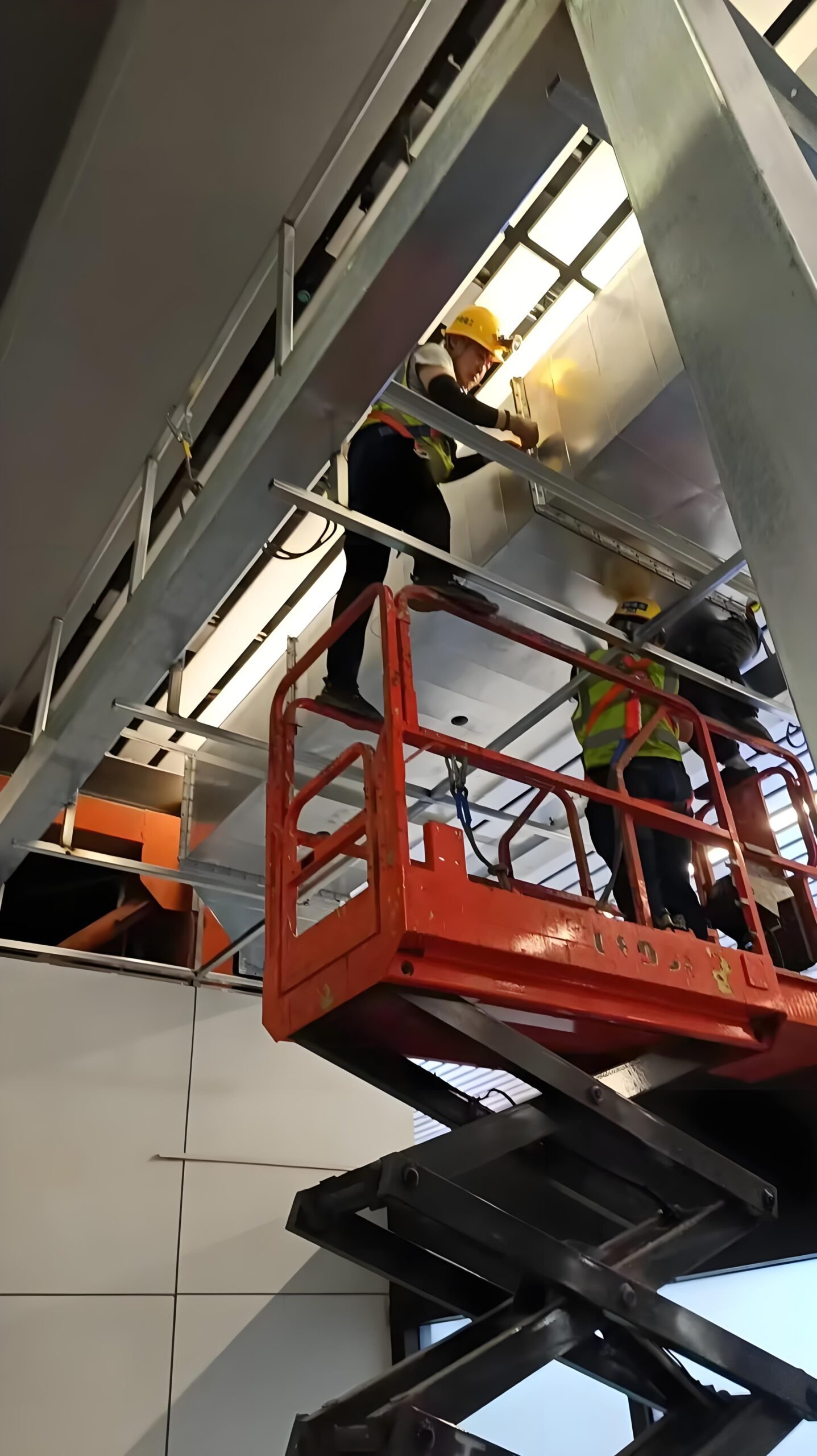 Technician accessing elevated industrial equipment during maintenance work